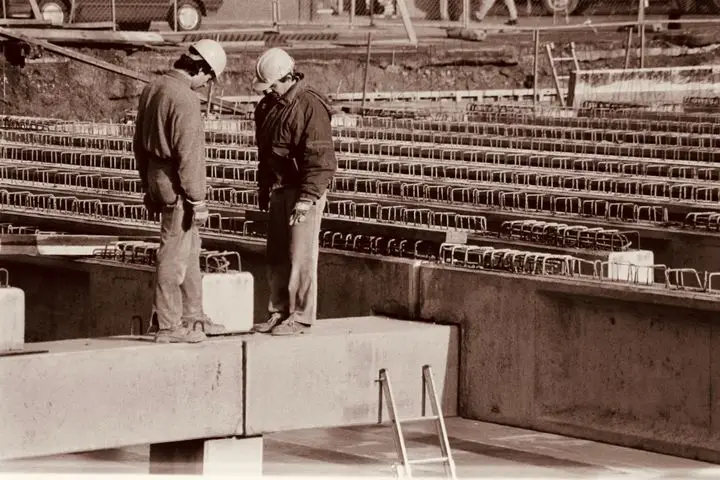 Construction professionals analyzing plans together on site.