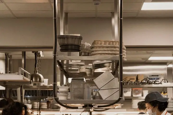 Restaurant kitchen team preparing meals together during service.