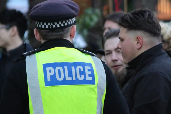 Police officer speaking with members of the public during a community contact.