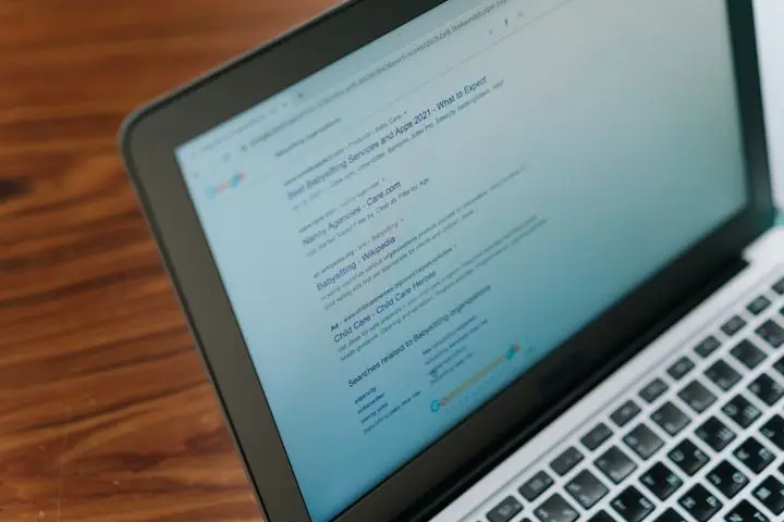SEO specialist reviewing an organic search results page on a laptop.