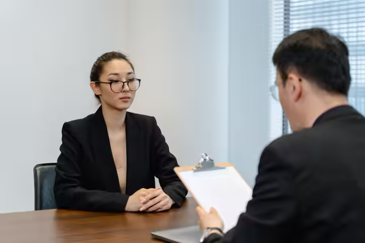 Business interview scene with professionals in office setting.
