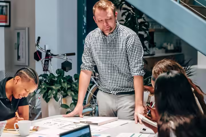 Diverse team engaged in a collaborative meeting in a modern office setting.