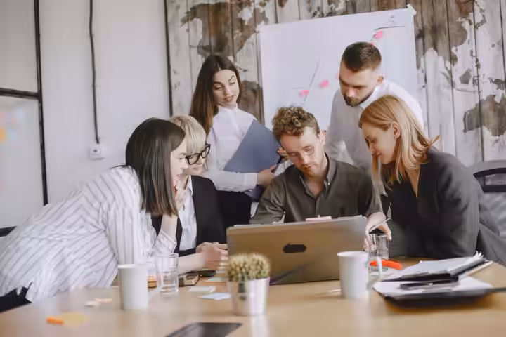 A diverse team works together in a modern office setting, fostering innovation.