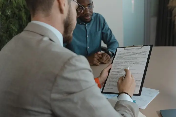 Recruiter reviewing an application during an interview.